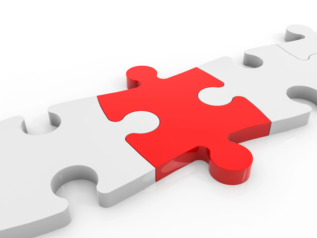 Red puzzle piece among white pieces to signal link.