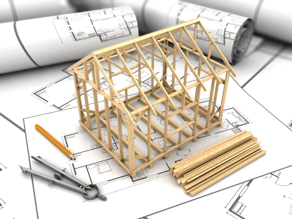 House frame of sticks on top of architecture plan.