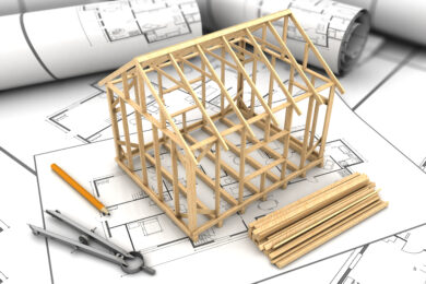 House frame of sticks on top of architecture plan.