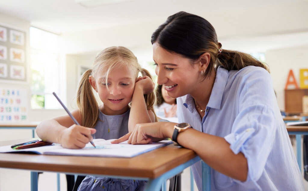 Teacher in conferring with student to differentiate writing istruction.
