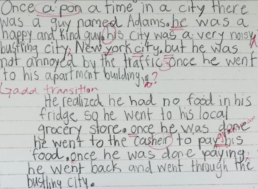 Image shows student writing on white paper with red pen corrections.